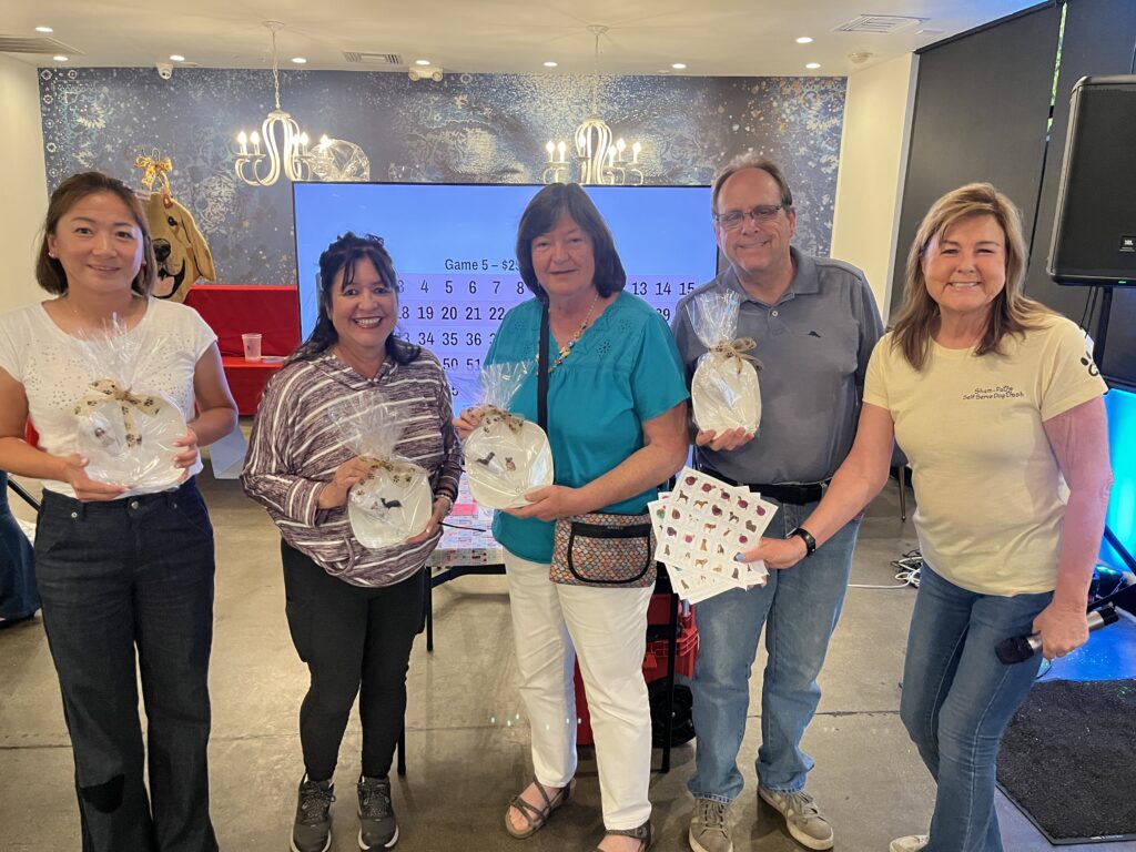 Bingo Night winners with prizes at a Labradors and Friends fundraiser