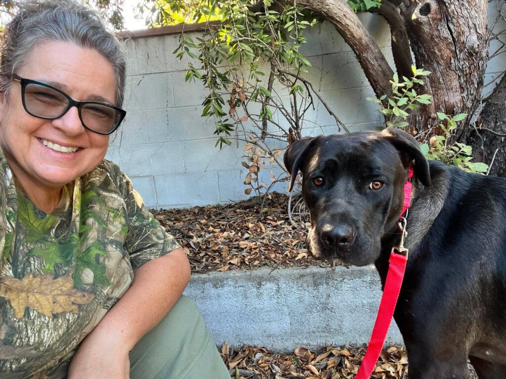 Jesse sitting outside beside his foster mom as they spend time together.