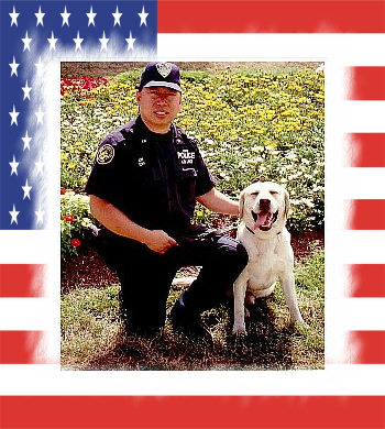 PAPD Officer David Lim kneeling beside his yellow Labrador K-9 partner Sirius before September 11, 2001
