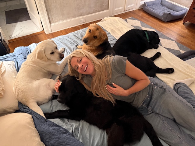 Grandpa Cody relaxing with Allison and his new canine family in his forever home