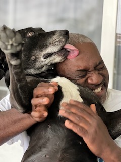 Apple enjoying a cuddle with her dad during her life with the Toliver's.