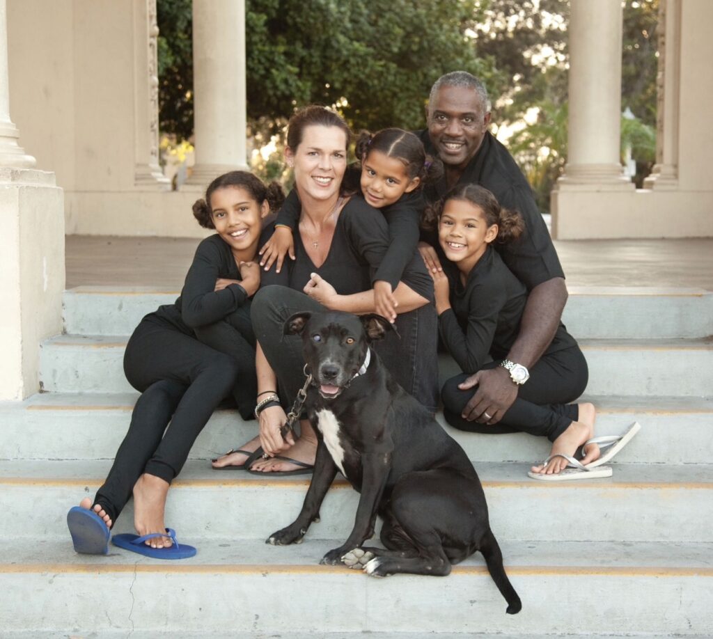 Apple sitting with the Toliver family during a family portrait, surrounded by the people who loved her for more than eleven years.