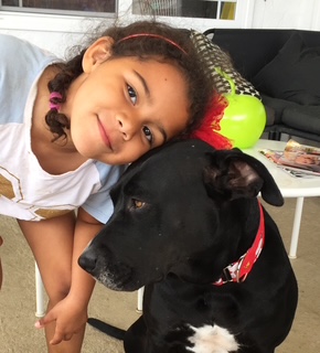 Apple cuddling with one of the Toliver daughters, who grew up with her as a beloved member of the family.