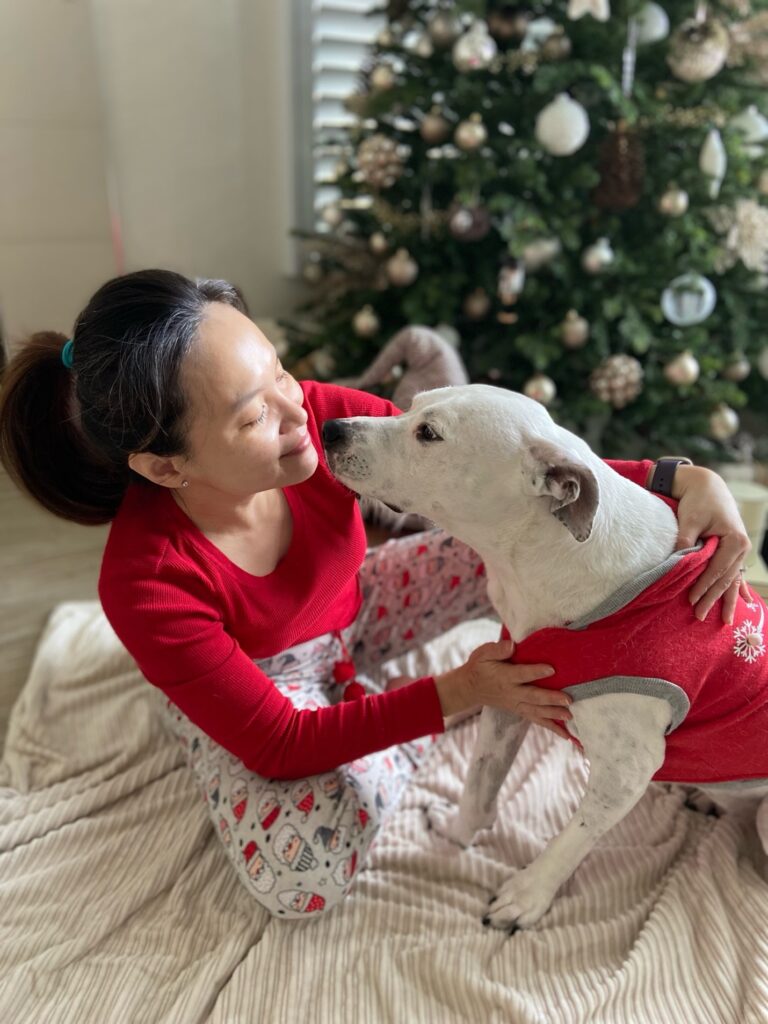 Dottie sharing an affectionate moment with Irene beside a decorated Christmas tree.