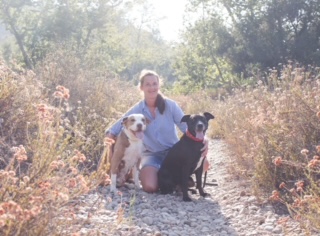 Apple posing outdoors with her mom, Nicole, and one of her doggie siblings during a family photo session.
