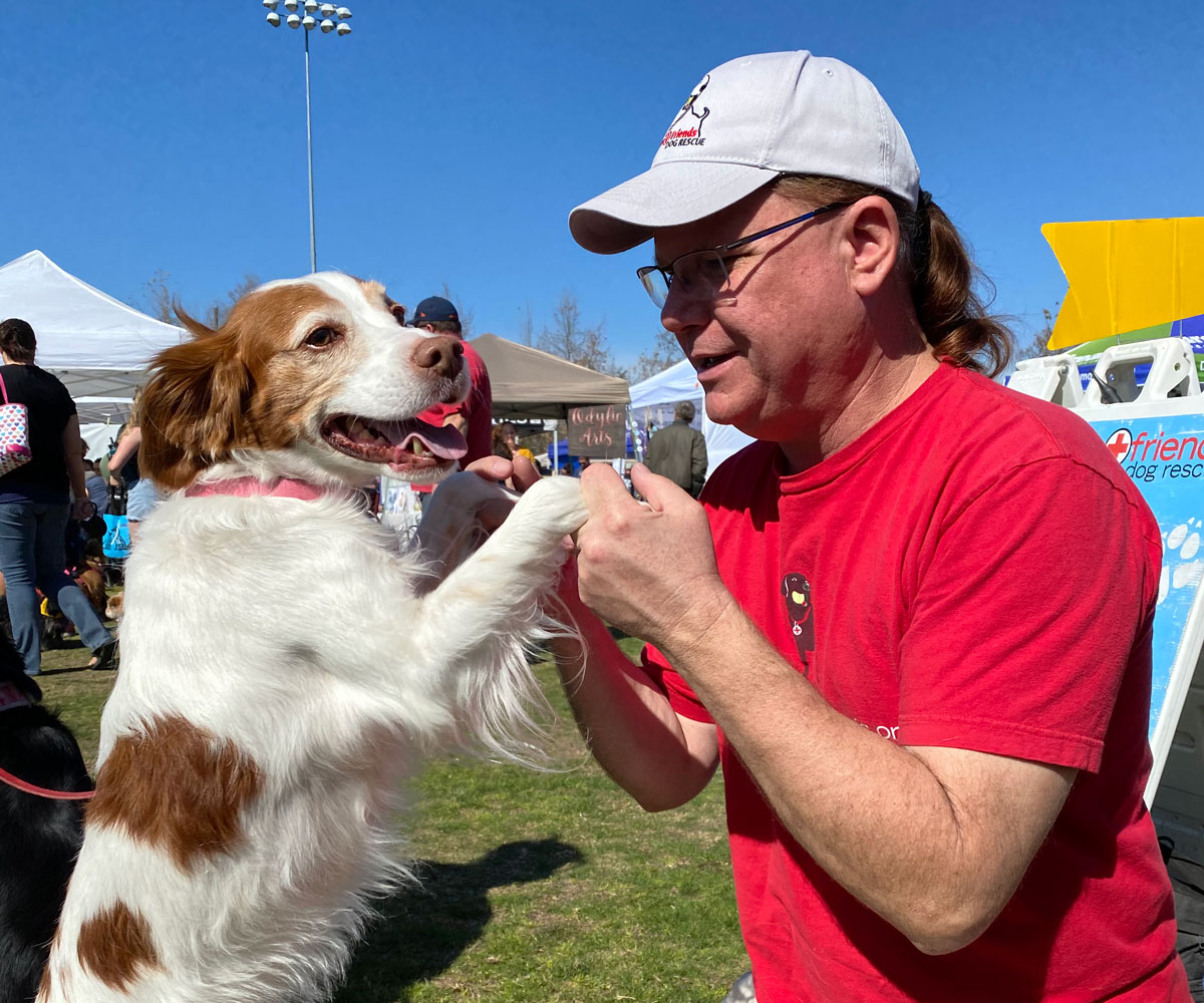 volunteer with dog at event